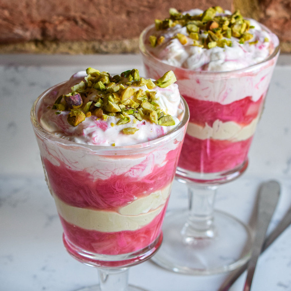 Layered rhubarb compote and creamy pistachio fool in a serving glass.